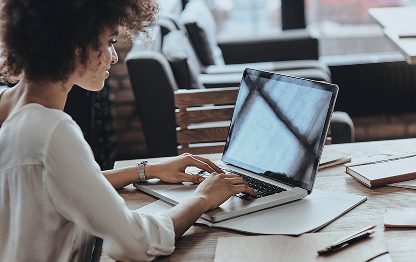 Woman on laptop in at home office setting